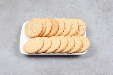 A plate of crispy biscuits on marble background