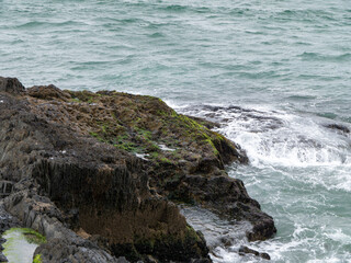 Wild rocks and sea water, landscape, rock formation beside body of water. Ocean