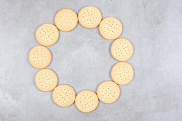 Ring of crispy biscuits on marble background