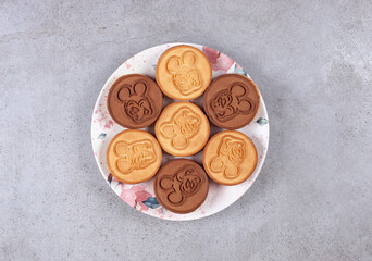 Fototapeta premium Tart cookies on decorated plate on marble background