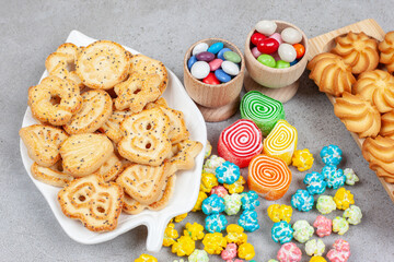 Assortment of cookies and candies with marmelades on marble background