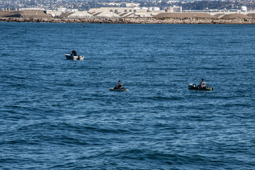 Fishermen on small boats on the San Diego Bay area