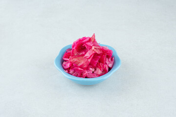 Obraz na płótnie Canvas Pickled red cabbage in blue bowl