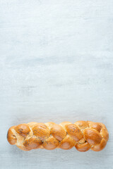 White braided bread on stone background
