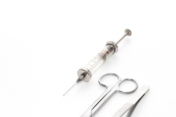 medical instrument, scissors, tweezers, syringe filled with medicines, on a white background
