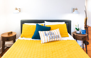 Yellow bedding on bed and interior of a bedroom