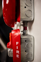 Fire alarm and mock sprinkler system attached to a white wall used for training