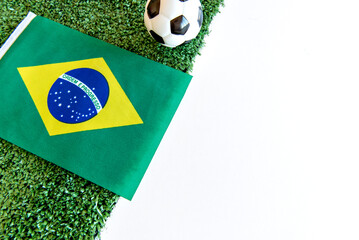 Fototapeta premium soccer ball and brazilian flag on white background
