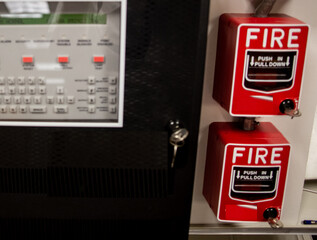 Fire alarm and mock sprinkler system attached to a white wall used for training