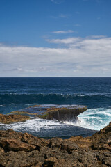 big wave coming to the rocks on the beach