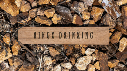 binge drinking disease. Written on wooden surface. Wooden frame on pieces of stone. Diseases and...