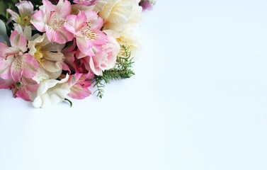 Light pink alstroemeria in a festive bouquet on a white background. Delicate floral arrangement. Background for a greeting card.