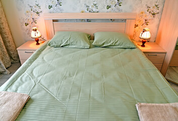 Double bed with green linen
