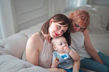 family consisting of mother son and grandmother on the sofa