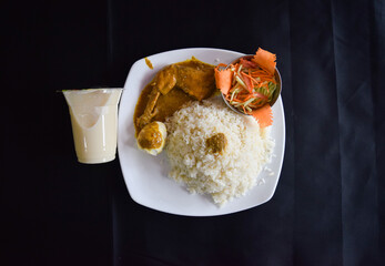 Polao and Roast. Tasty Indian Pulao with Chicken Roast. Biriyani with chicken curry on white plate.
