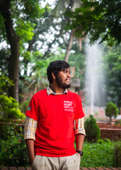 South asian young male medical student wearing red t shirt in awareness about world heart day campaign 