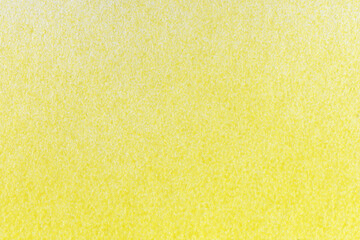 macro photography of yellow spray paint on white paper