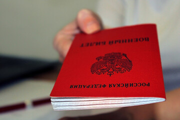 The girl holds out a military ID issued by the Russian Federation. The concept of mobilization....