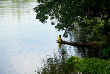 Fisherman in the boat on the river, Thailand