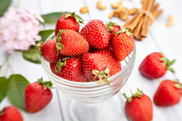 strawberries bowl on bright wood background