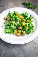 olive salad, leaf lettuce, mache corn lettuce fresh healthy meal food snack diet on the table copy space food background