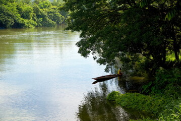 A fisherman in the boat on the  river