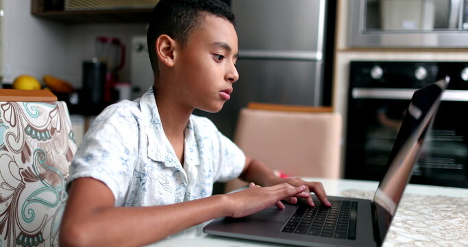 Black Kid In Front Of Laptop At Home. Child Browsing Internet Online Computer