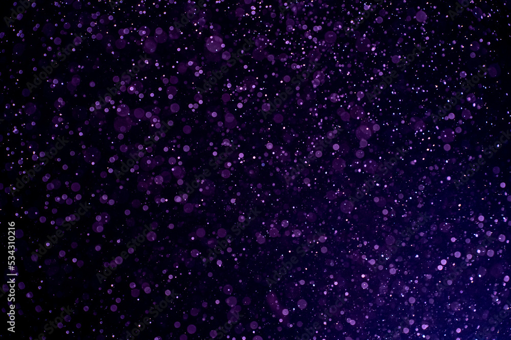 Wall mural dust blue particles on black background. glittering sparkling bokeh overlay with copy space for text
