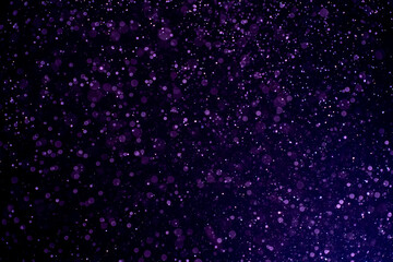 Dust blue particles on black background. Glittering sparkling bokeh overlay with copy space for...