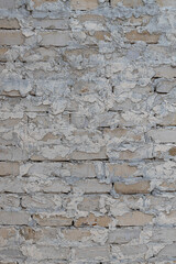vertical background brick wall covered with a layer of plaster (Corrected).
