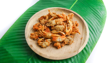 Fried crabs on wooden plate served on wooden plate and banana leaf