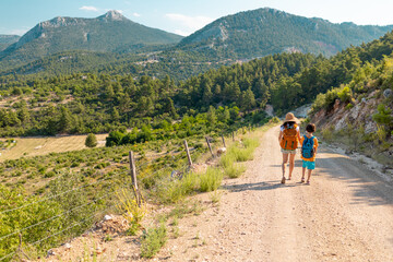 Obraz premium The boy with his mother go hiking.
