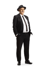 Obraz na płótnie Canvas Elegant mature man in black suit and tie wearing a fedora hat