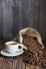 Cup of coffee and beans in jute sack