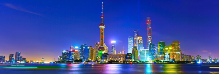 Fototapeta na wymiar View of the skyline along the riverside at night in Shanghai, China.