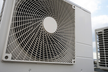 Modern industrial heat pump or air conditioning system outdoor unit close-up view, modern green...