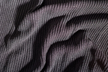 Wrinkled background of black colored wool texture