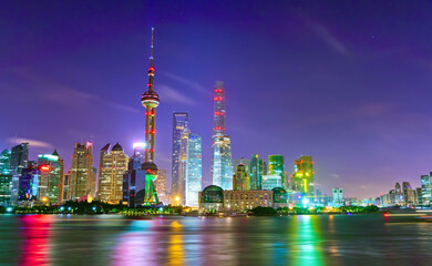 View of the skyline along the riverside at night in Shanghai, China.