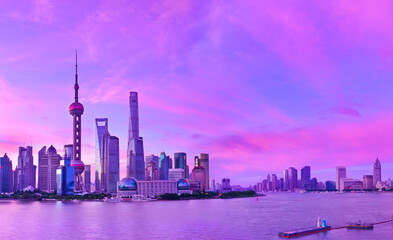 Obraz premium View of the skyline along the riverside at sunrise in Shanghai, China.
