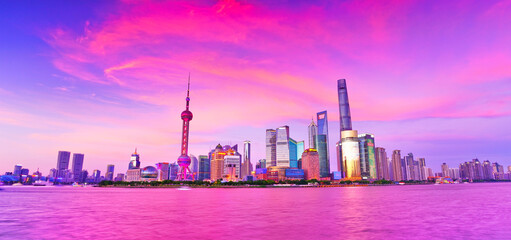 View of the skyline along the riverside at dusk in Shanghai, China.