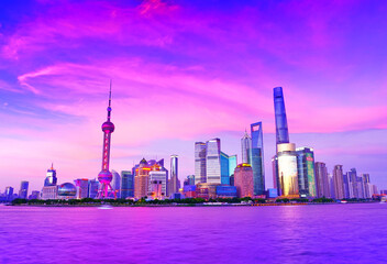 Fototapeta premium View of the skyline along the riverside at dusk in Shanghai, China.