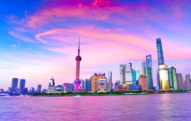 View of the skyline along the riverside at dusk in Shanghai, China.