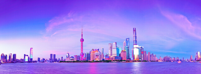View of the skyline along the riverside at dusk in Shanghai, China.