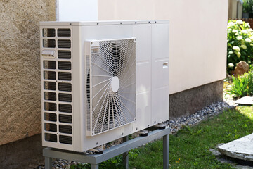 Heat pump or air conditioning outdoor unit in modern house of future using green electric energy,...