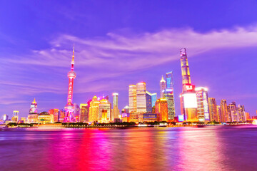 Obraz na płótnie Canvas View of the skyline along the riverside at night in Shanghai, China.
