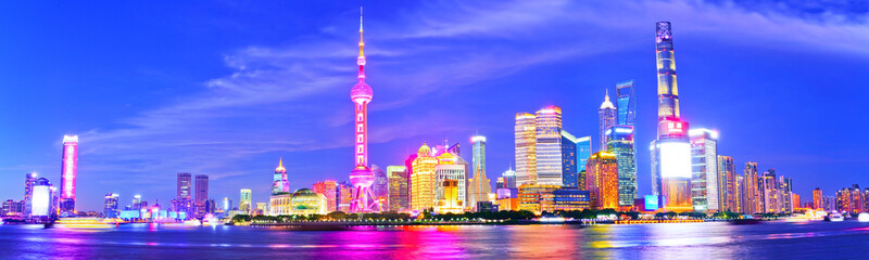 Fototapeta na wymiar View of the skyline along the riverside at night in Shanghai, China.