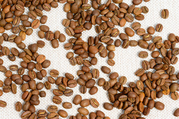Coffee beans detailed on the background, aromatic coffee beans, place for inscription.