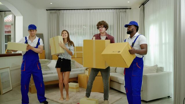 House movers and homeowners having fun dancing
