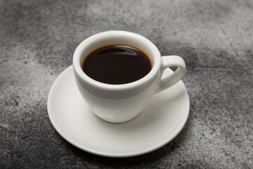 Cup of coffee on a dark background. Hot fragrant coffee on a textural background. Place for copy space.Place for text. Flat lay.