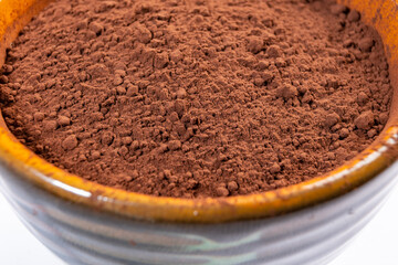 cocoa powder in a bowl shot on a macro lens, powder for making chocolate.